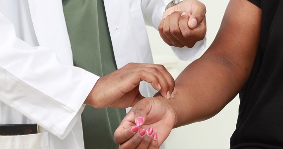 Doctor checking patient's pulse